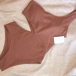 NEVER WORN one piece suit w/ tags & hygiene strip.